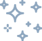 Plusieurs étincelles pixelisées gris-bleu scintillantes sur fond noir. Évoque la propreté ou la magie.